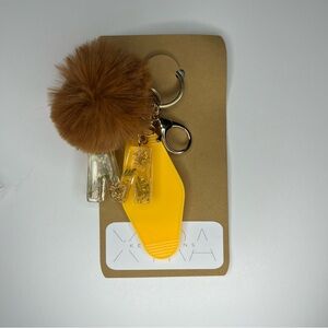 Brown Pom Pom Keychain with Yellow Hotel Tag and Letter M